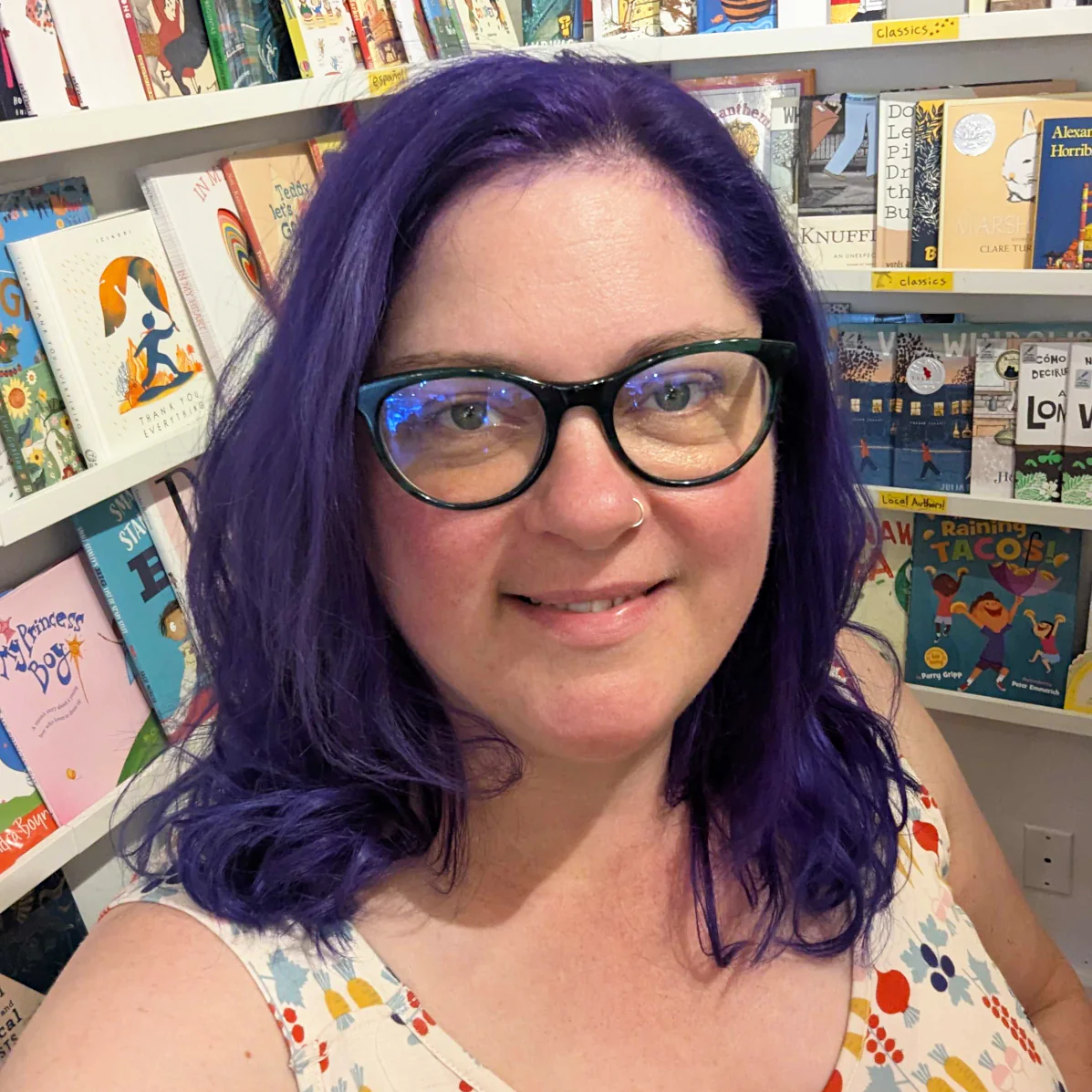 Karen has purple hair and is wearing cat-eyed glasses.