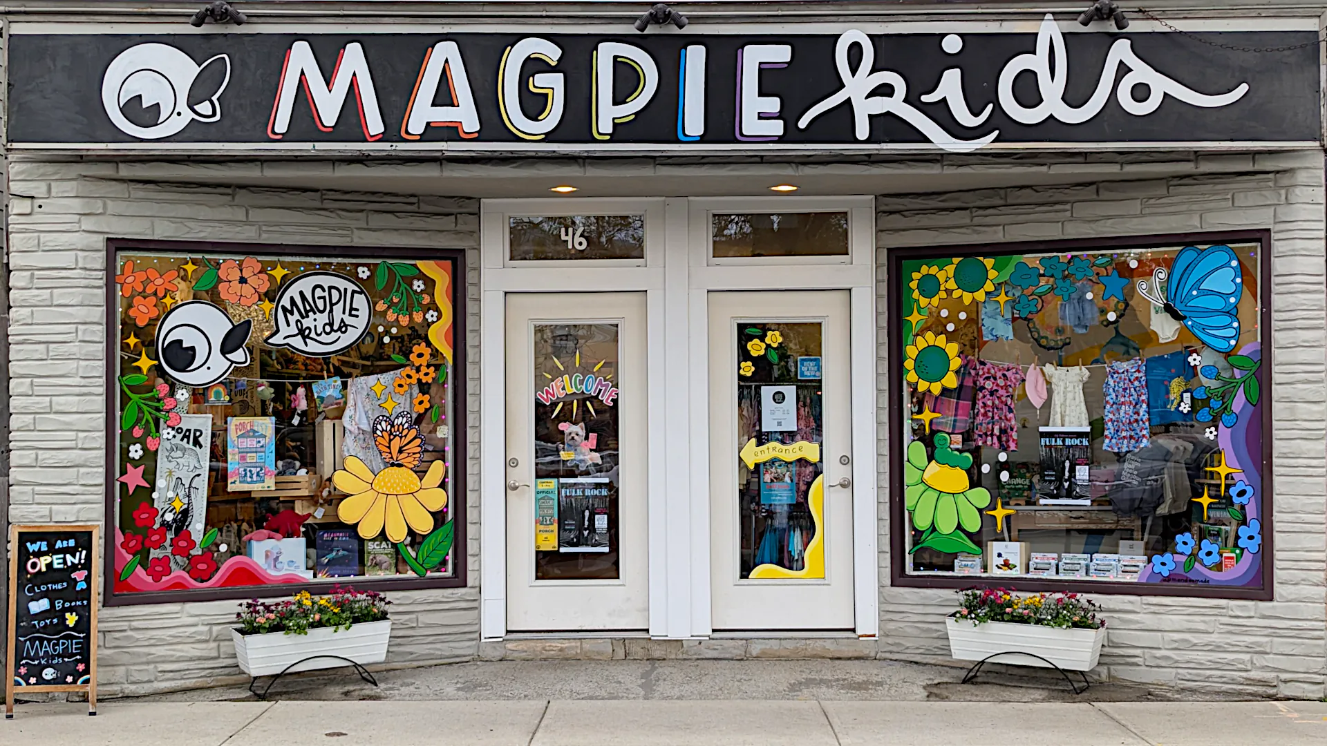 Our cheerful and colorful storefront, right across from Porter Square Shopping Center. Window painting by https://www.mandeemade.com/